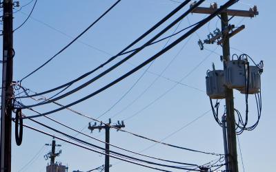 utility poles and lines against a blue sky