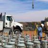 A crew from Provo Power works with NTUA during the Light Up Navajo initiative in 2025. An array of pole mount transformers is in the foreground.