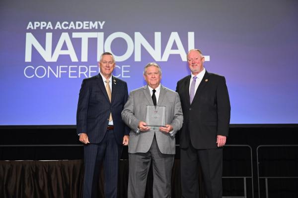 David Osburn, Thomas Heller, and Tony Cannon pose as Heller receives his award.