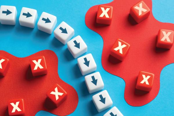 small blocks with arrows making a curved pathway around small blocks with exes