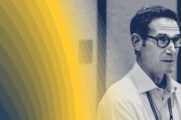 Black-and-white photo of person speaking into a microphone