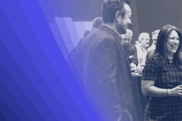 Black-and-white image of a group of people talking with a blue-hued overlay