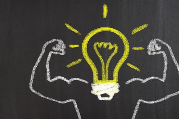 chalkboard drawing of a light bulb with strong arms