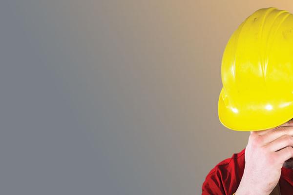 Man in hardhat showing distress