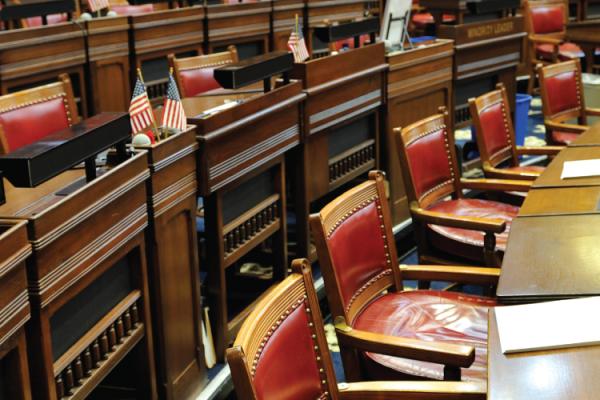 detail of seats in a legislative chamber with US flags