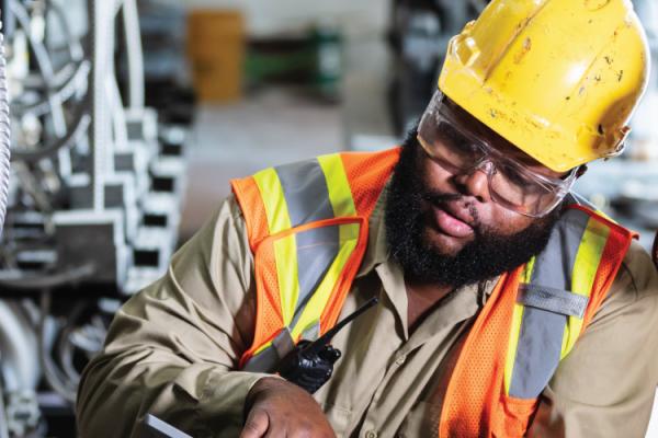 two utility workers inspect wiring