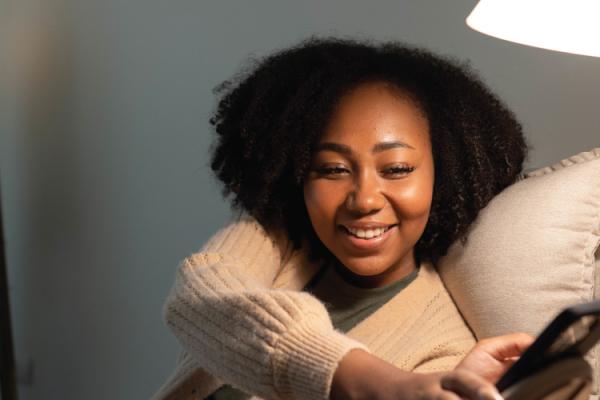 woman using a light and electronic devices at home