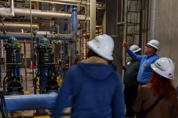 A group on a tour of a power plant as part of PWC Day in Fayetteville, North Carolina