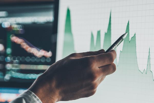 person pointing at a chart