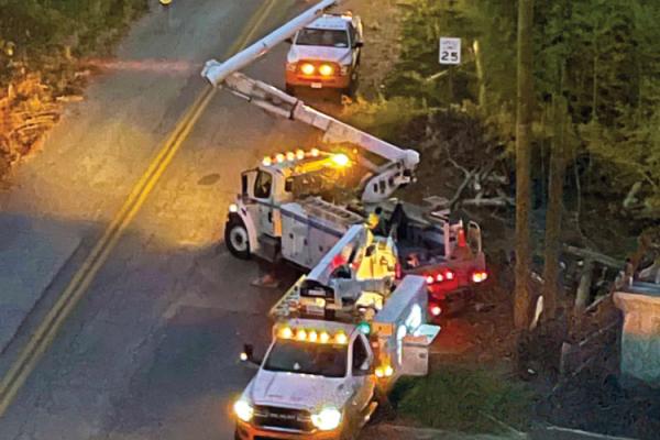 Bucket trucks on a storm response effort at night