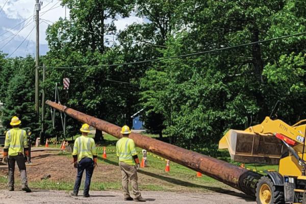 Crews with Marquette Board of Power and Light install new utility poles