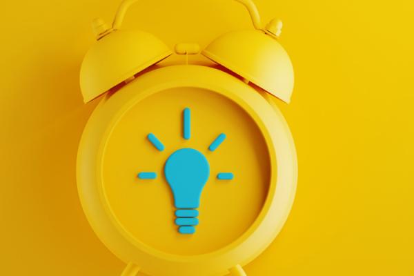 yellow alarm clock on yellow background