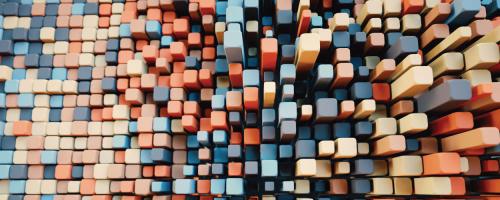 Aerial view of tightly packed colorful square pegs of varying heights