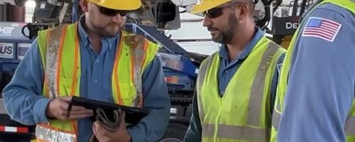 Three workers in a safety briefing