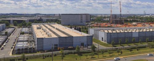 Row of data centers next to a road with construction in background