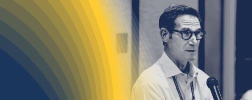 Black-and-white photo of person speaking into a microphone