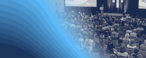 Black-and-white image of people in a large conference session with a blue graphic overlay