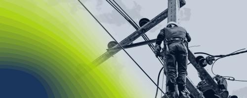 Lineworker atop utility pole