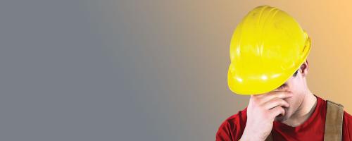 Man in hardhat showing distress