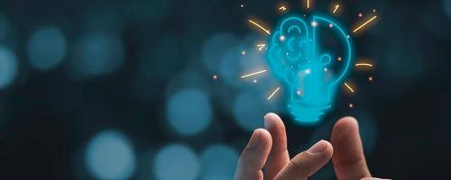 light bul and brain icon floating above a hand