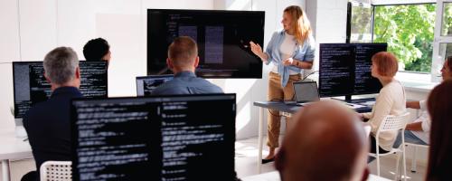 woman leading a training in front of computers
