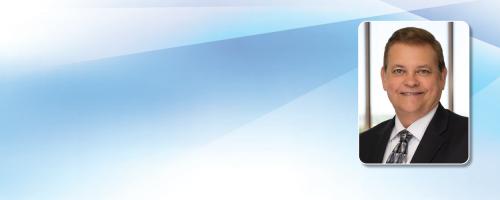 Headshot of Michael Beckham on a wavy blue background