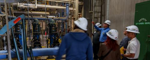 A group on a tour of a power plant as part of PWC Day in Fayetteville, North Carolina