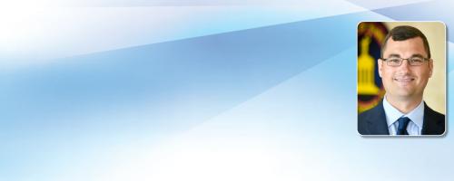 Edwin Porter headshot over a blue-white gradient background