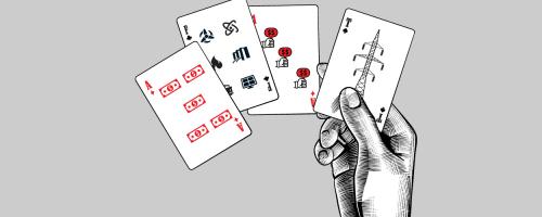 sketch of a hand holding cards with energy symbols on them