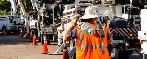 electric utility trucks and workers