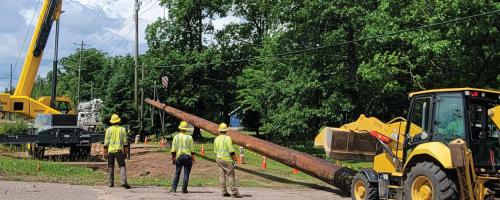 Crews with Marquette Board of Power and Light install new utility poles