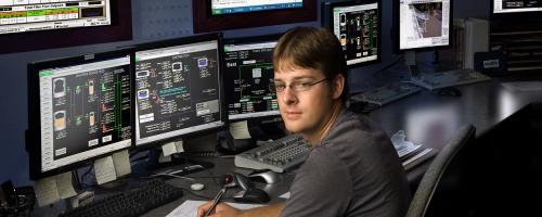 Worker at computer controls at Nearman plant