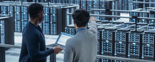 Two people talking inside a data center